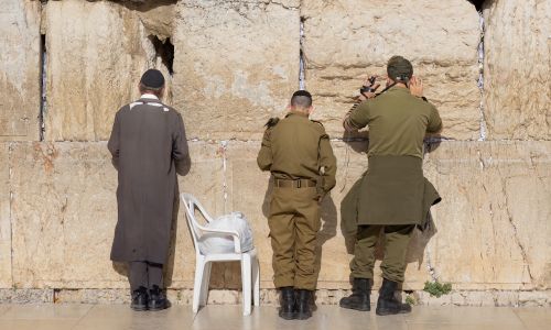 Israeli Jews standing at the Western Wall in Jerusalem
